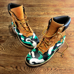 Green, white and black camo style painted boots. Painted on waterproof Timberland Boots. Signed @wrenandglory.