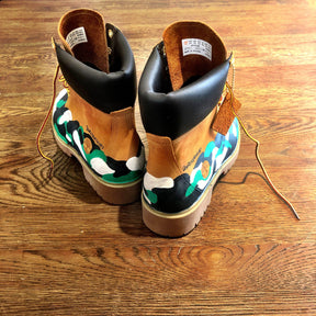 Green, white and black camo style painted boots. Painted on waterproof Timberland Boots. Signed @wrenandglory.