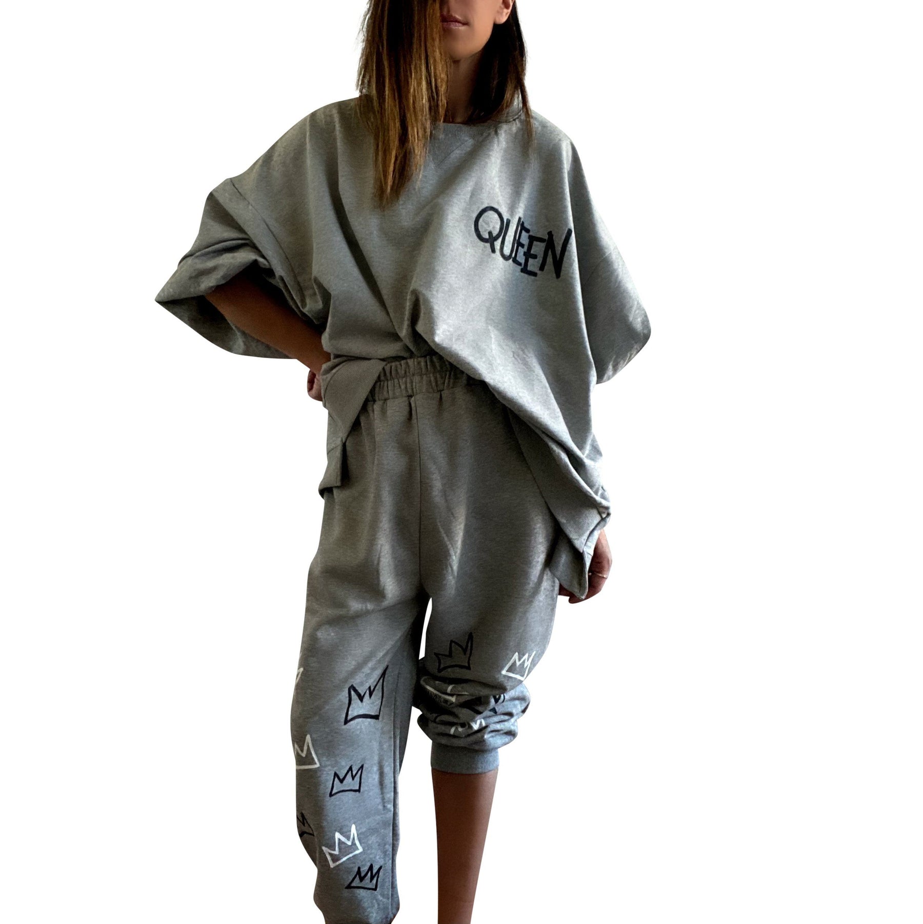 The perfect oversized sweatshirt & jogger loungewear set. TOP: Large crown painted on back in black, with white paint drips. QUEEN painted in black, on front left chest. BOTTOM: QUEEN painted on back going down leg in black, with white paint drips. Assorted sized crowns painted in black and white on front. Signed @wrenandglory on both top and bottom.