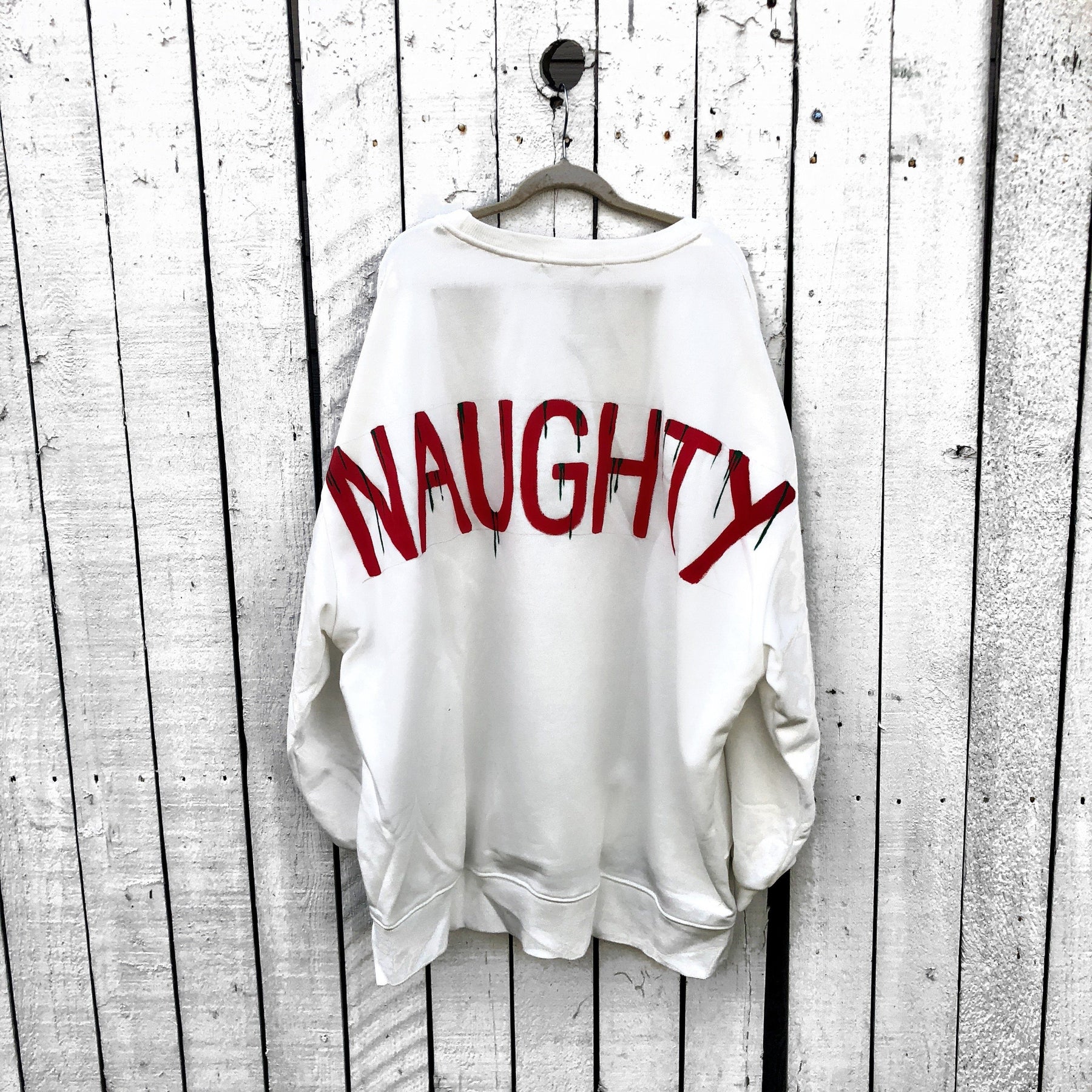 'NAUGHTY' PAINTED SWEATSHIRT