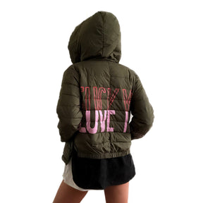 Perfect army green puffer jacket. On back, painted 'LOVE/FCK YOU' in pink and red. Bottom on left sleeve painted with pink hearts all around. Signed @wrenandglory.