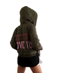 Perfect army green puffer jacket. On back, painted 'LOVE/FCK YOU' in pink and red. Bottom on left sleeve painted with pink hearts all around. Signed @wrenandglory.