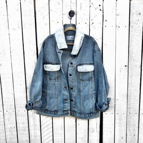 Lighter blue denim wash. Large white heart on back with MAMA painted inside in black. Smaller black hearts surrounding the larger one, customized with kids names. Collar and front pockets painted white. Signed @wrenandglory.